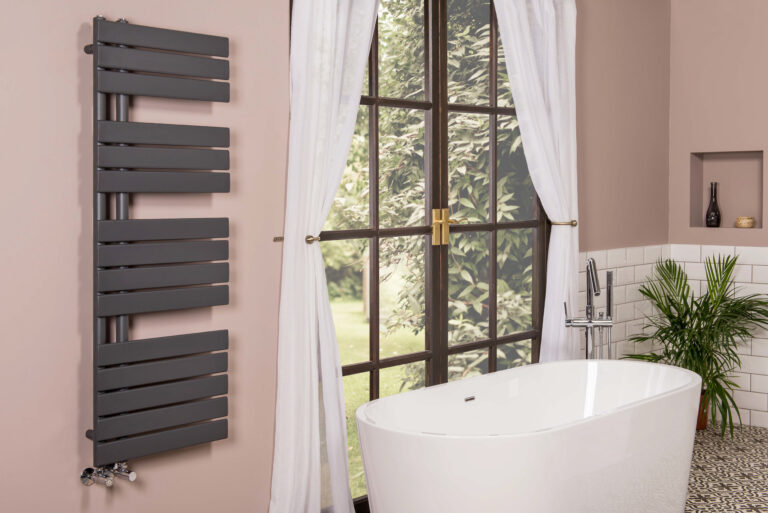 A modern style bathroom with a view of a garden from a window